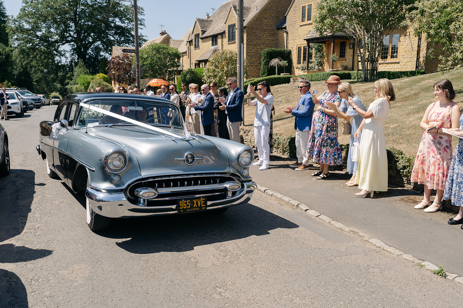 Luxury wedding car in Chipping Campden Cotswolds with bride and groom arriving at countryside venue