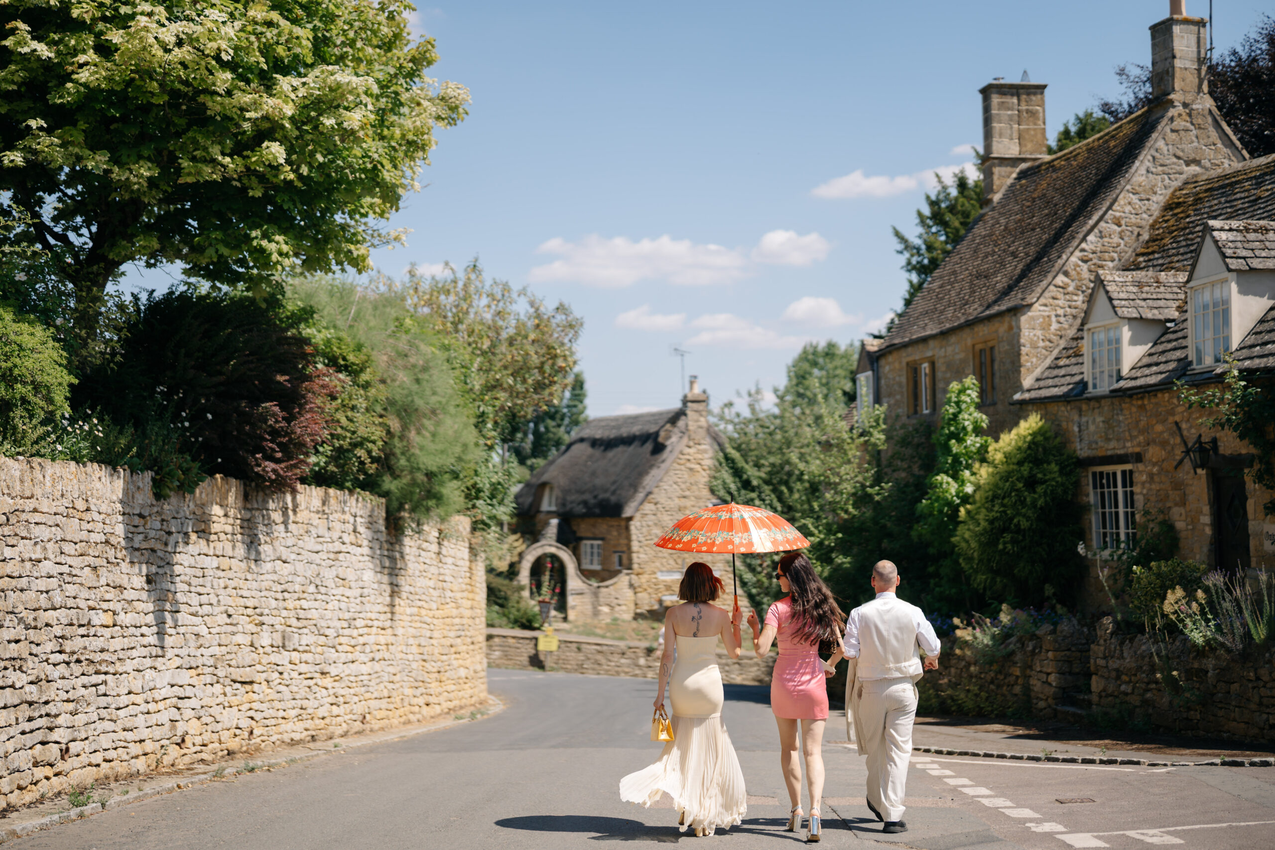 Wedding guests walking village street