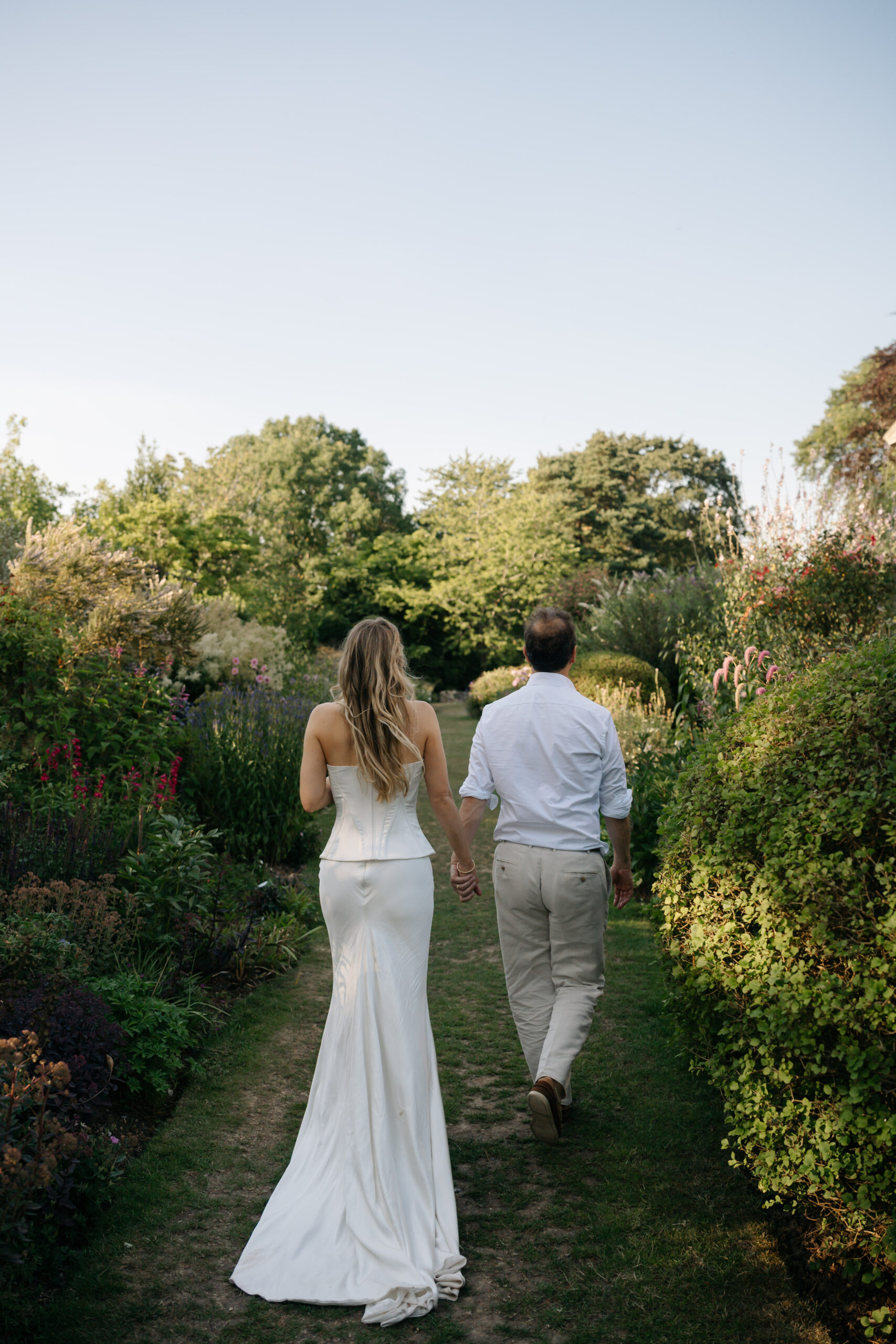 Bride and groom walking countryside