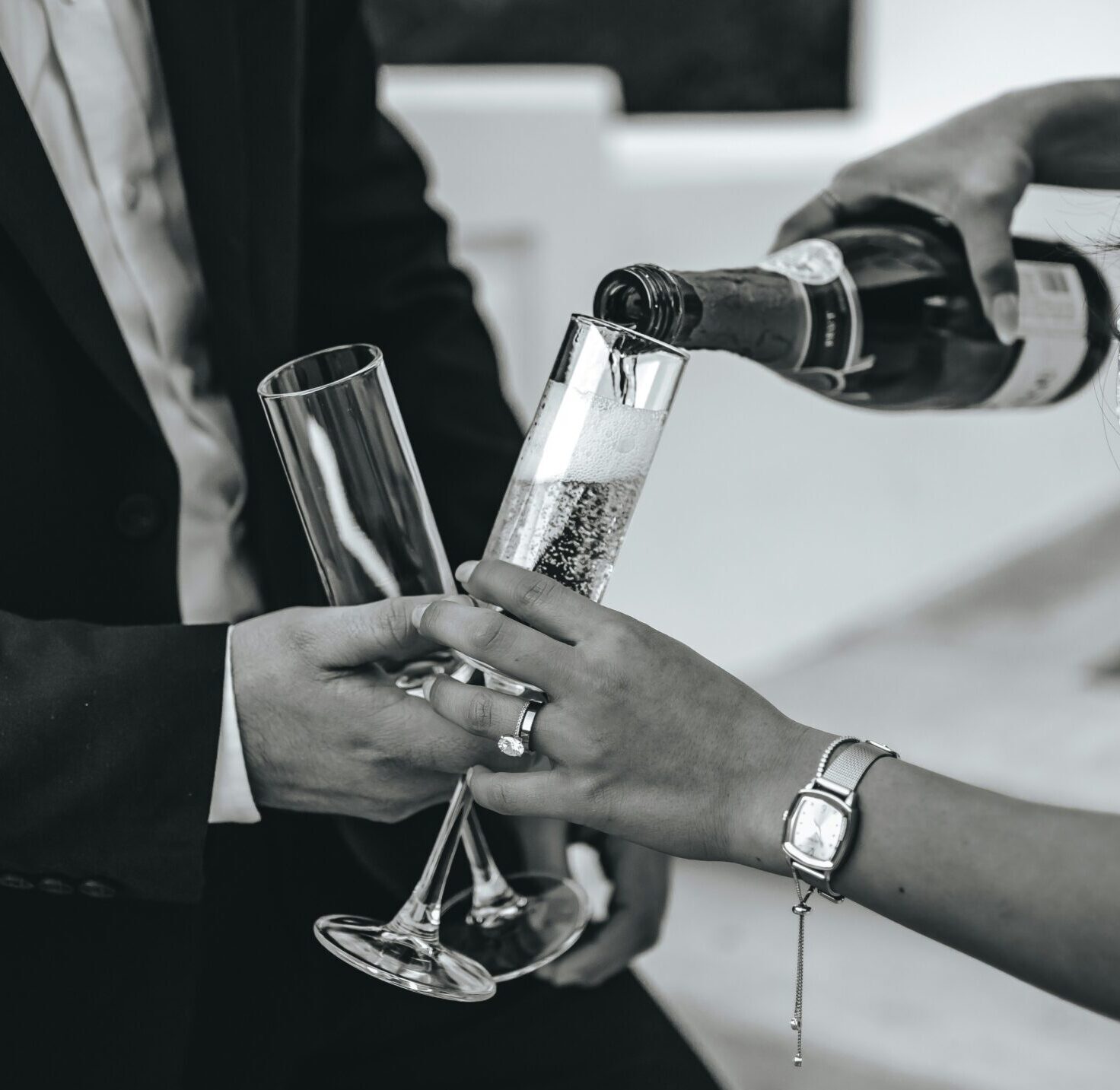 Champagne being poured into glass at Cotswolds wedding drinks reception
