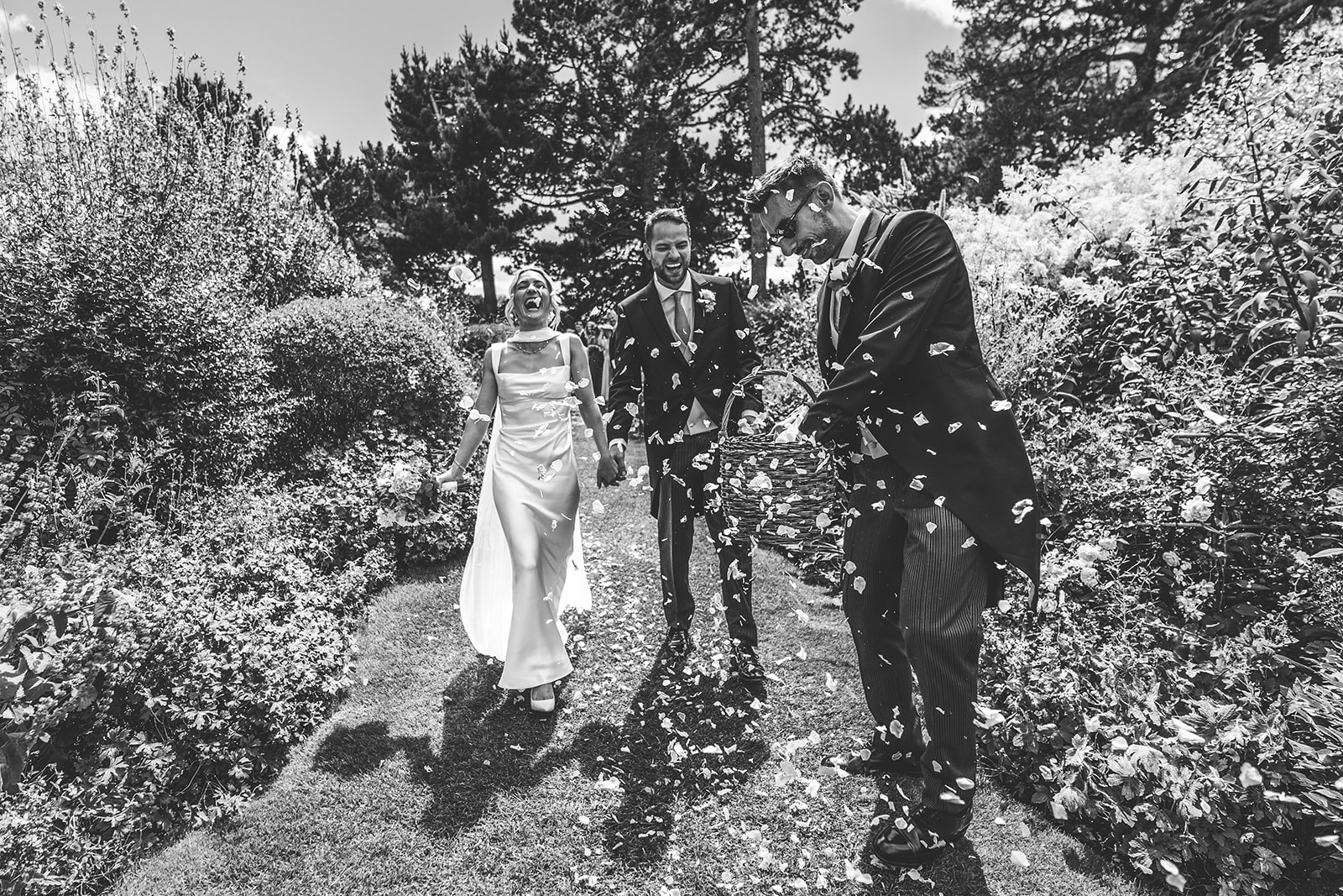 Newlyweds walking through the gardens at Kiftsgate Court Gardens in the Cotswolds